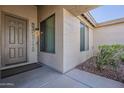 Welcoming front entrance featuring a decorative glass sidelight and views of the courtyard at 14837 W Crocus Dr, Surprise, AZ 85379