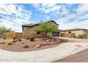 Two-story home with a neutral stucco exterior, tile roof, dark garage door, desert landscaping, and mature landscaping at 1525 W Bent Tree Dr, Phoenix, AZ 85085