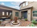 Beautiful front entrance featuring a fountain, covered patio, and brick-paved courtyard at 1525 W Bent Tree Dr, Phoenix, AZ 85085