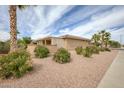 A desert landscaped backyard with an attached patio featuring shade and privacy at 17335 W Gould Mine Ln, Surprise, AZ 85387