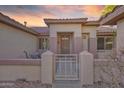 Charming single-story home with a gated front courtyard, desert landscaping, and a tile roof at 17882 N Painted Spurge Ct, Surprise, AZ 85374