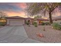 Charming single-story home with desert landscaping, a two car garage, and a tile roof at 17882 N Painted Spurge Ct, Surprise, AZ 85374