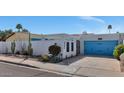 Single-story home with a blue garage door, desert landscaping, and an enclosed front courtyard at 2065 E Alameda Dr, Tempe, AZ 85282