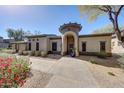 Charming stucco home with a turret-style entrance and meticulously landscaped front yard at 20802 N Grayhawk Dr # 1017, Scottsdale, AZ 85255