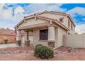 Charming home with a two-car garage and welcoming porch, complemented by desert landscaping at 21 W Red Mesa Trl, San Tan Valley, AZ 85143