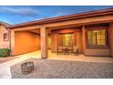 Inviting covered patio with outdoor seating, creating a cozy and welcoming entrance to the home at 25903 S Lemon Ave, Queen Creek, AZ 85142