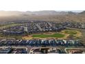 Wide aerial shot of a community near a golf course showcasing beautiful homes, lush greens and a serene environment at 27138 W Escuda Dr, Buckeye, AZ 85396