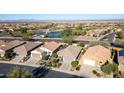 An aerial view showcasing houses and a golf course near a pond at 27138 W Escuda Dr, Buckeye, AZ 85396