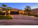 Charming single-Gathering home featuring a two-car garage, lovely brick driveway, and lush landscaping at 29219 W Clarendon Ave, Buckeye, AZ 85396