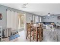 Well lit dining area with wood flooring, a ceiling fan, and sliding glass doors to the backyard at 3049 E Santa Rosa Dr, Gilbert, AZ 85234