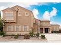 Beautiful two-story home featuring desert landscaping, tan paint and shutters, and a covered front entryway at 3317 W Knudsen Dr, Phoenix, AZ 85027