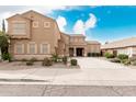 Beautiful two-story home featuring desert landscaping, tan paint and shutters, and a covered front entryway at 3317 W Knudsen Dr, Phoenix, AZ 85027