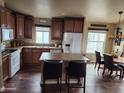 Well-lit kitchen features wood cabinets, an island, and a nearby dining area with natural light at 3504 N Hawes Rd # 3504, Mesa, AZ 85207