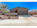 Single-story home featuring a two-car garage, stone accents, and desert landscaping at 3903 E French Trotter St, San Tan Valley, AZ 85140