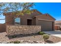 Single-story home featuring a two-car garage, stone accents, and desert landscaping at 3903 E French Trotter St, San Tan Valley, AZ 85140