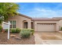 Charming home featuring a two-car garage, desert landscaping, and inviting arched entryway at 4121 E Narrowleaf Dr, Gilbert, AZ 85298