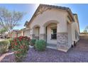 Charming single-story home featuring a two car garage, neutral stucco, and decorative stone accents at 4135 E Cathy Dr, Gilbert, AZ 85296