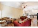 Open-concept living room with views of the kitchen, breakfast nook and hardwood flooring throughout at 44087 W Granite Dr, Maricopa, AZ 85139