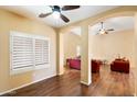 Inviting living room with hardwood floors, white window shutters, and archways to the rest of the home at 44087 W Granite Dr, Maricopa, AZ 85139