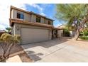 Attractive exterior view of a two-story home with desert landscaping and a spacious driveway at 44961 W Miraflores St, Maricopa, AZ 85139