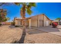 Home with desert landscaping, a lush palm tree, and a view of the car port at 5115 W Surrey Ave, Glendale, AZ 85304