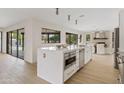 Gourmet kitchen with waterfall island, modern appliances, and ample counter space at 5819 E Ludlow Dr, Scottsdale, AZ 85254