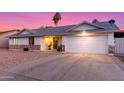 Single-story home featuring a two-car garage, desert landscaping, and covered front entry at 6237 E Inglewood St, Mesa, AZ 85205