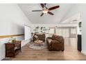 Bright living room featuring hardwood floors, ceiling fan, and comfortable seating area at 6237 E Inglewood St, Mesa, AZ 85205