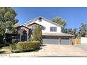 Charming two-story home features a three-car garage, brick accents, and mature landscaping at 6834 E Culver St, Mesa, AZ 85207