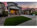 Charming two-story home featuring a welcoming porch and lush green turf lawn at 717 E Deer Creek Rd, Phoenix, AZ 85048