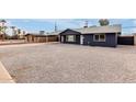 Charming single-story home featuring a low maintenance gravel yard, covered parking and a fresh modern paint job at 8014 N 55Th Ave, Glendale, AZ 85302