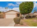 Inviting home showcasing a tidy front yard, mature landscaping, and a two-car garage at 812 W Rosal Pl, Chandler, AZ 85225