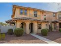 Charming two-story home with a tiled roof, arched porch entry, and maintained desert landscaping at 919 S Pheasant Dr, Gilbert, AZ 85296