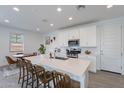 Bright and airy kitchen featuring white cabinets, stainless steel appliances, and an island with seating at 9918 E Tahoe Ave, Mesa, AZ 85212