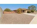 Single-story home showcasing a tidy yard, covered patio and extended driveway at 9946 W Willow Creek Cir, Sun City, AZ 85373