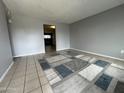 Spacious living room with neutral paint, tile floors, and a geometric rug at 1210 E Marny Rd, Tempe, AZ 85288