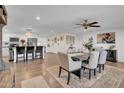 Open-concept dining room featuring wood floors, a ceiling fan, and access to the kitchen at 14446 N 40Th Pl, Phoenix, AZ 85032