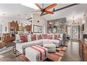 Spacious living room featuring a vaulted ceiling, beams, fireplace and tiled flooring at 1453 E Butler Cir, Chandler, AZ 85225