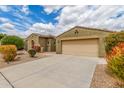 A beautiful, neutral-colored single-story home with a two-car garage and a spacious, clean concrete driveway at 18178 W Desert View Ln, Goodyear, AZ 85338