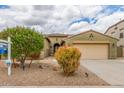 Charming single-story home with a two-car garage, desert landscaping, and mature trees in a desirable neighborhood at 18178 W Desert View Ln, Goodyear, AZ 85338