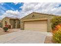 A beautiful, neutral-colored single-story home with a two-car garage and a spacious, clean concrete driveway at 18178 W Desert View Ln, Goodyear, AZ 85338