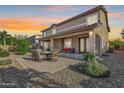 Exterior featuring a covered patio with an outdoor seating area for relaxation at 18436 E Celtic Manor Dr, Queen Creek, AZ 85142