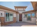 Welcoming entrance courtyard with a brick pathway and a view of the home's front door at 18925 W Windsor Blvd, Litchfield Park, AZ 85340