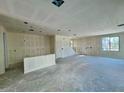 Large unfinished living room area with stairway, recessed lighting and several windows at 1909 W Lariat Ln, Phoenix, AZ 85085