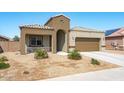 Charming single-story home with a two-car garage and low-maintenance xeriscaped front yard at 23830 W Romley W Ave, Buckeye, AZ 85326