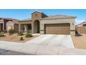 Inviting single-story home with a two-car garage and a tidy, desert-friendly front yard at 23830 W Romley W Ave, Buckeye, AZ 85326