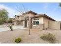 Exterior view of a multi-story house with stone accents, desert landscaping, and a spacious driveway at 2748 W Sunland Ave, Phoenix, AZ 85041