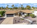 Landscaped home exterior view with walkway and a gray two-car garage, showcasing curb appeal at 302 W Thunderbird Rd, Phoenix, AZ 85023