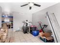 A large room filled with items, featuring tile floors and a ceiling fan at 323 N Hunt E Dr, Mesa, AZ 85203