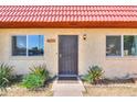 Close up front exterior featuring a secure front door with a screen and desert landscaping at 3324 W Tangerine Ln, Phoenix, AZ 85051